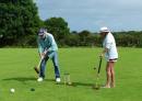 Randall and Judy locked in a game of killer croquet